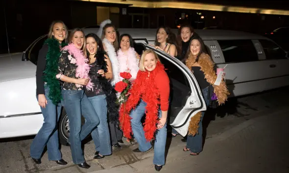 Friends enjoying a night out with a limousine